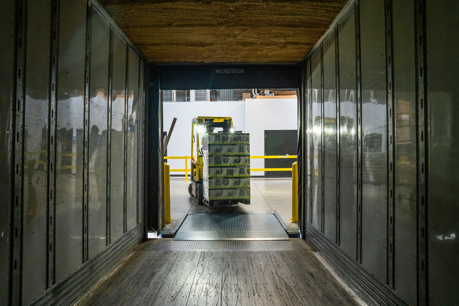 Medical Distributor List India Picture that shows a pallet truck storing a pallet with boxes into a container